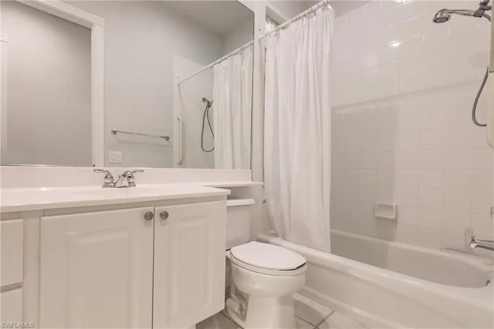 Full bathroom featuring shower / bath combo, tile patterned flooring, toilet, and vanity