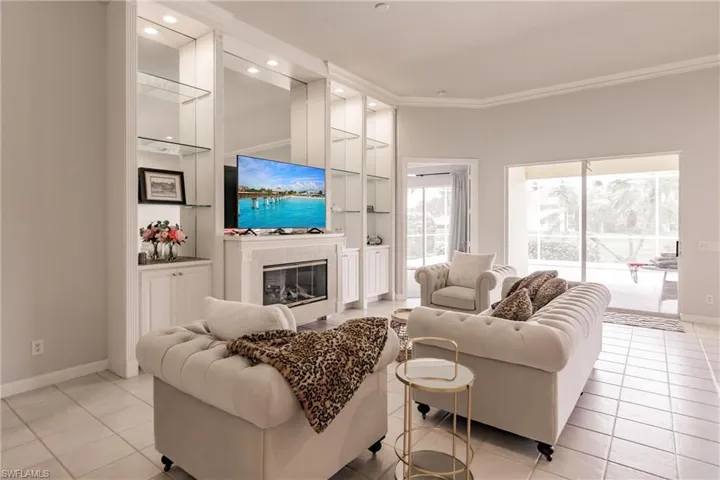Tiled living room featuring built in shelves