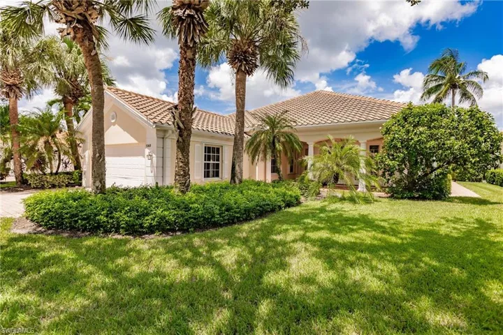 Mediterranean / spanish house featuring a garage and a front lawn