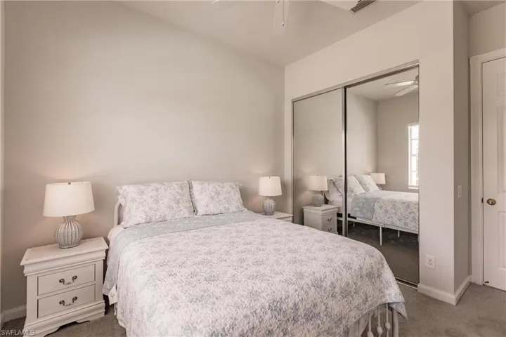 Carpeted bedroom featuring a closet and ceiling fan