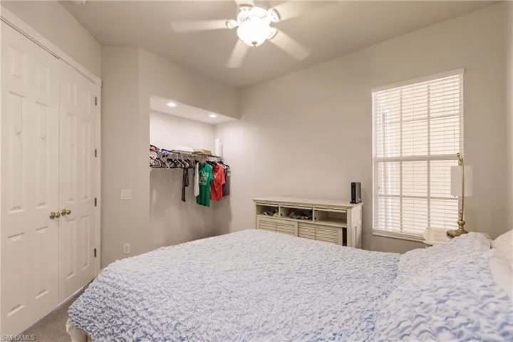 Bedroom featuring ceiling fan and carpet floors