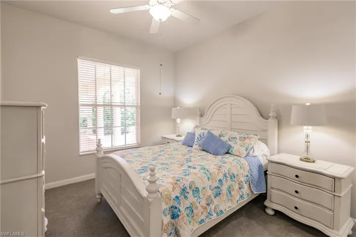 Carpeted bedroom with ceiling fan