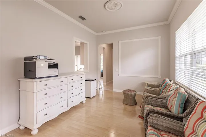 Sitting room featuring ornamental molding and light hardwood / wood-style flooring