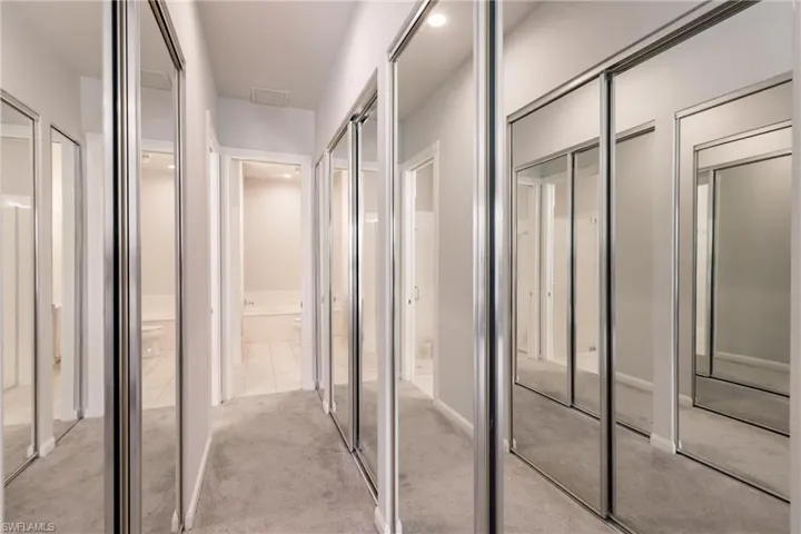 Hallway with light carpet