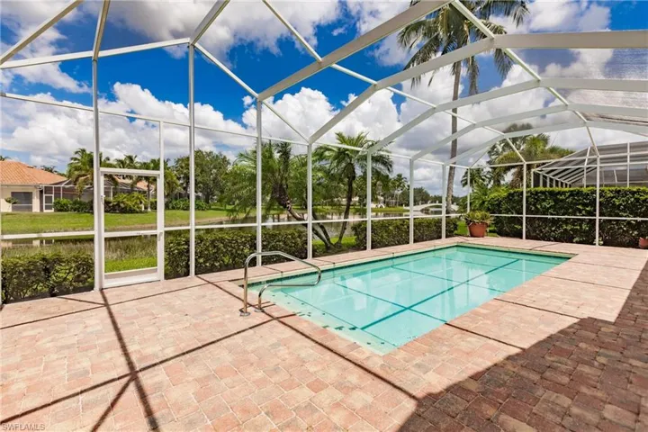 View of swimming pool featuring a lanai and a patio area