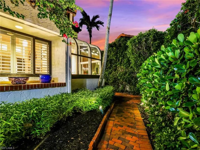 Private Walkway with Lush Landscaping to Courtyard at Night