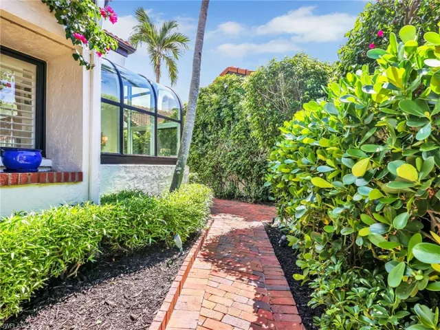 Private Walkway with Lush Landscaping to Courtyard