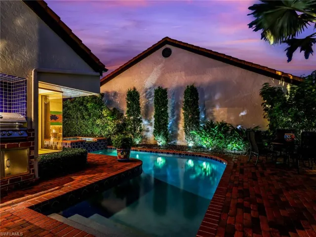 Courtyard with Heated Pool and Spa and Outdoor Kitchen at Night