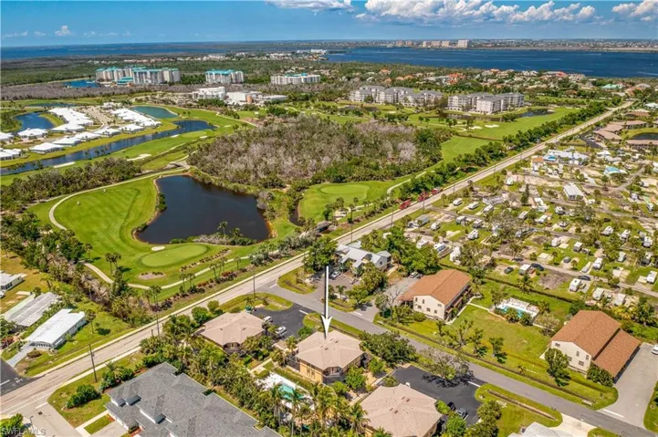 Aerial view with a water view and golf course view
