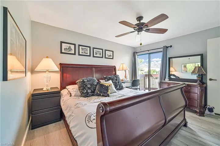 Bedroom featuring access to outside, ceiling fan, and wood finished floors