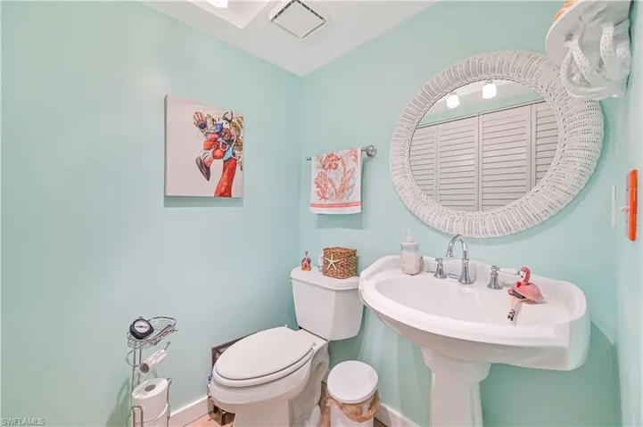 Half bath with toilet and baseboards