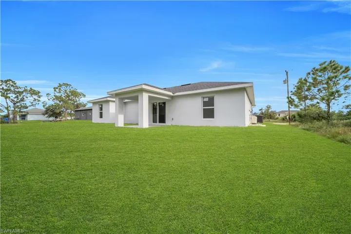 Expansive green lawn surrounds the property