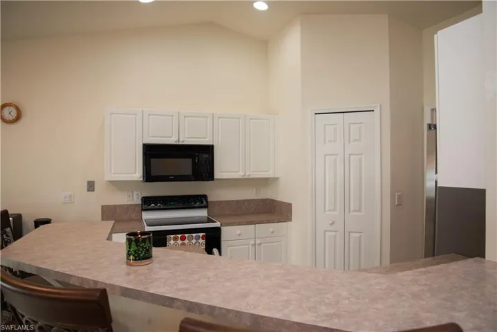 Full bath featuring light tile patterned flooring and toilet