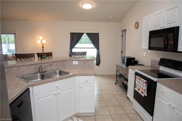 Bedroom featuring light wood-style flooring, ensuite bathroom, and a ceiling fan