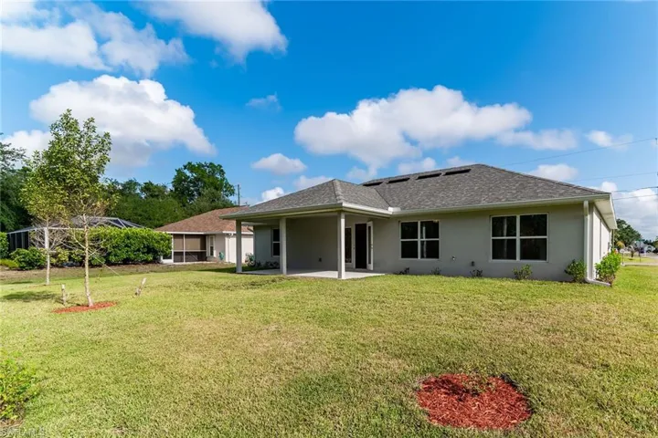 Back yard with covered porch.  Plenty of room for a pool.