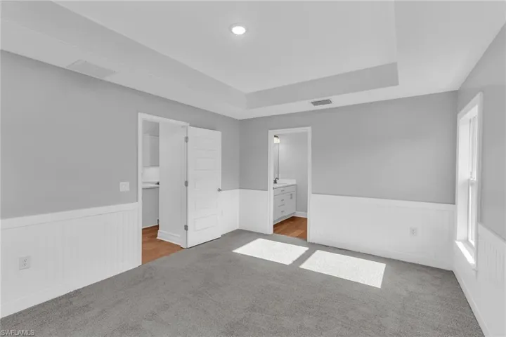 Primary Bedroom with tray ceiling and mill work.