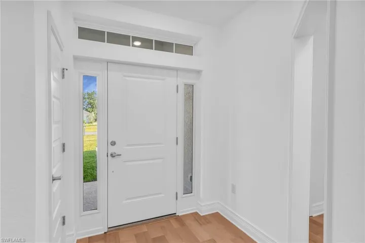 Front entry with transom windows.  Closet on left.