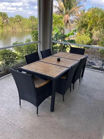The property features a screened patio with a water view and lush surrounding foliage