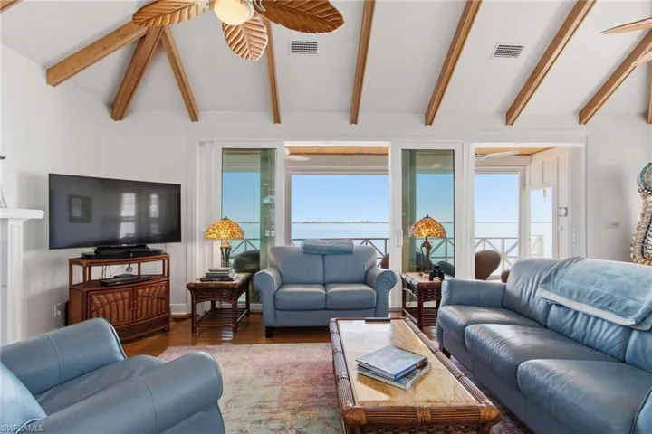 Living area with wood finished floors and a ceiling fan