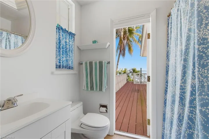 Bathroom featuring a shower with shower curtain, vanity, and plenty of natural light