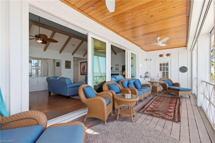 Sunroom with a ceiling fan and outdoor lounge area