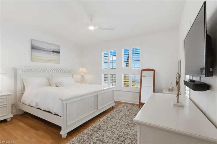 Bedroom with wood finished floors and ceiling fan