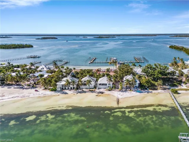 Aerial view of residential area featuring expansive coastline