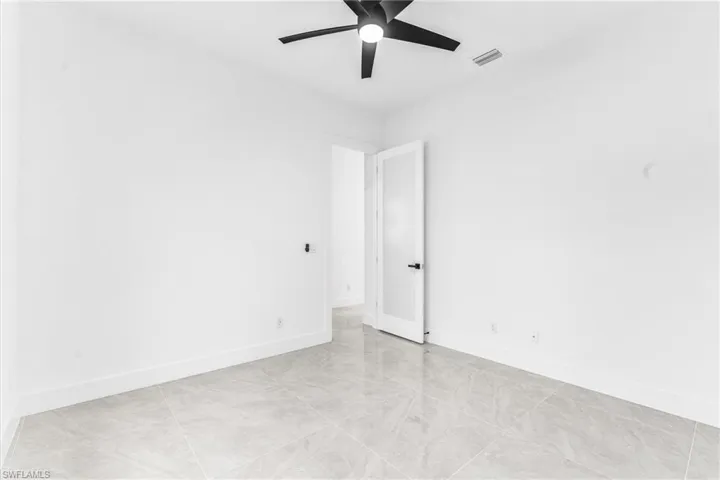 Spare room with ceiling fan