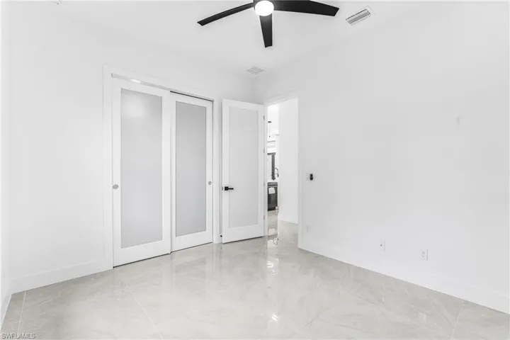 Unfurnished bedroom featuring a closet and ceiling fan