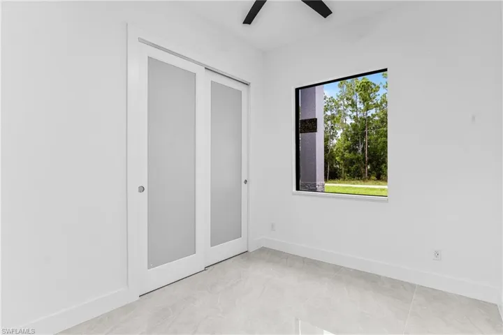 Unfurnished bedroom featuring ceiling fan and a closet