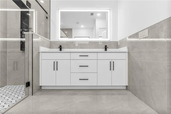 Bathroom featuring walk in shower and vanity
