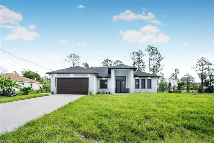 View of front facade with a front yard and a garage