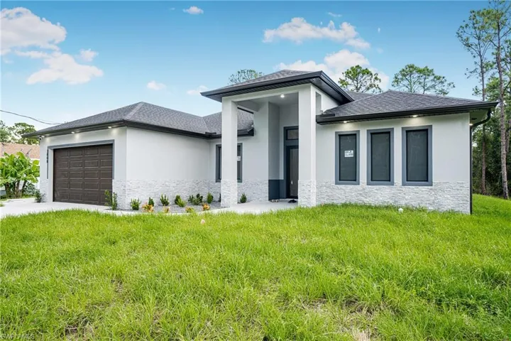 Prairie-style house featuring a front yard and a garage