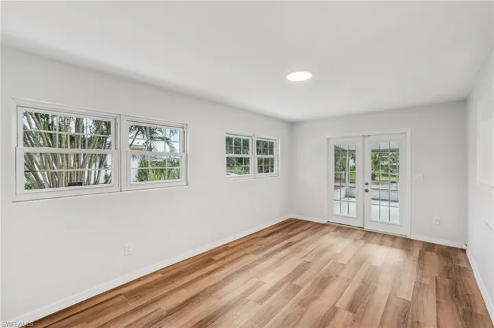 Empty room featuring french doors and light wood-style floors