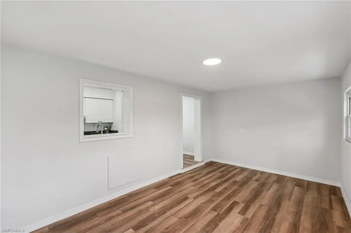Empty room with wood finished floors and recessed lighting