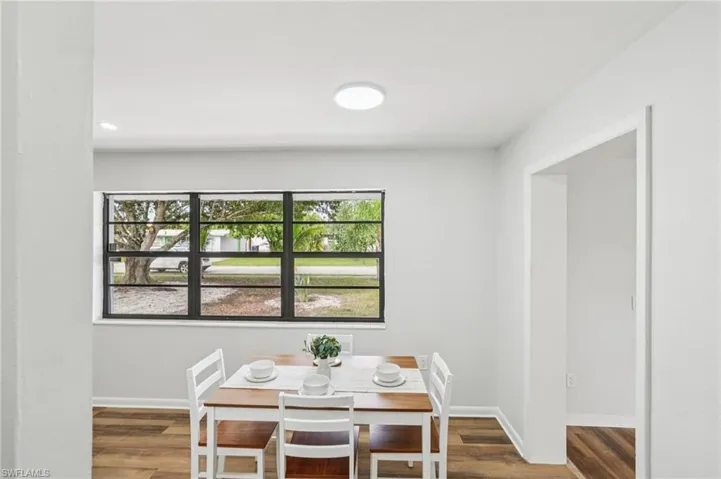 Dining room with wood finished floors and recessed lighting