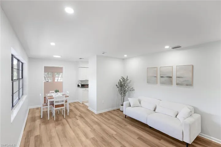 Living room featuring light wood-style floors and recessed lighting