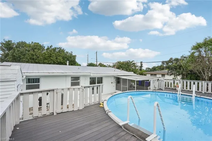 View of swimming pool with a roof deck