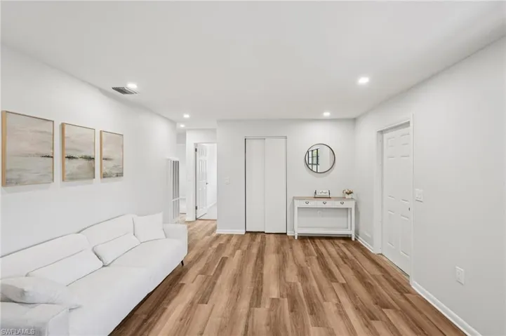 Living room featuring light wood-style floors and recessed lighting