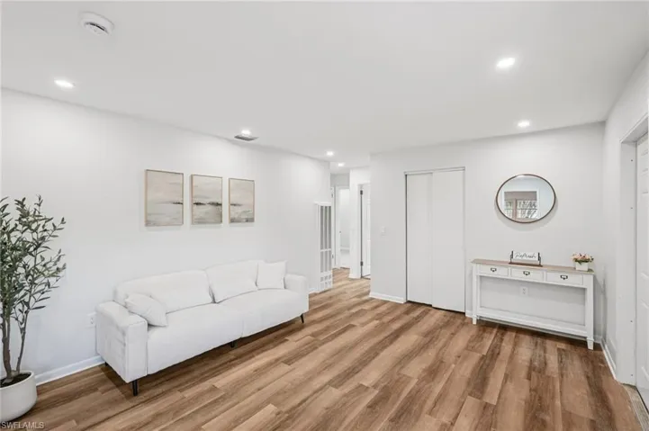 Sitting room with recessed lighting and light wood-type flooring