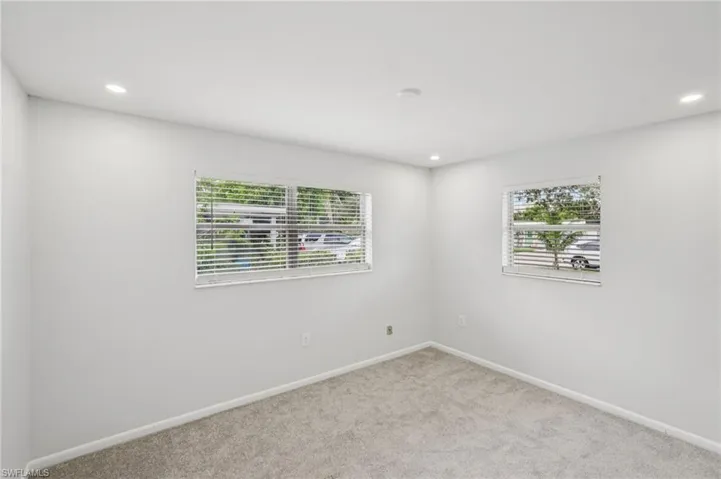 Empty room with recessed lighting and carpet floors