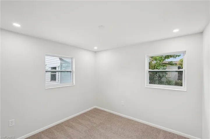 Empty room featuring carpet flooring and recessed lighting
