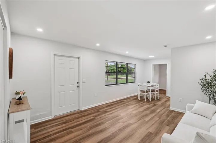 Living room with recessed lighting and wood finished floors