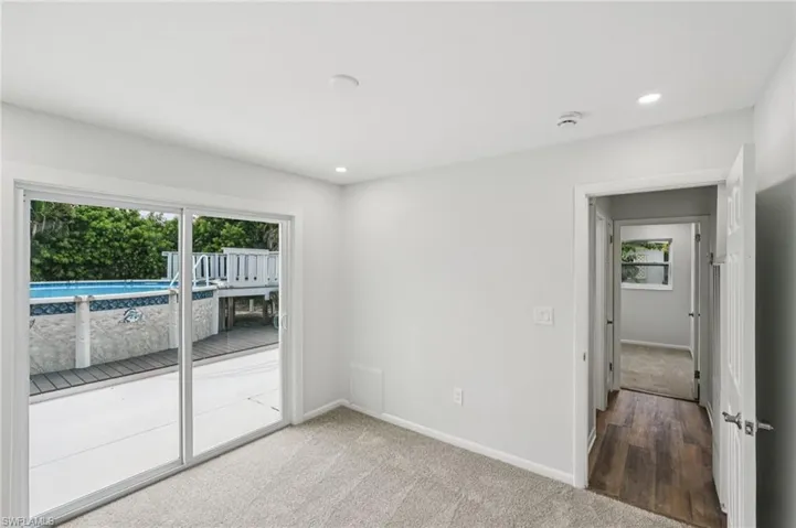 Carpeted spare room featuring recessed lighting
