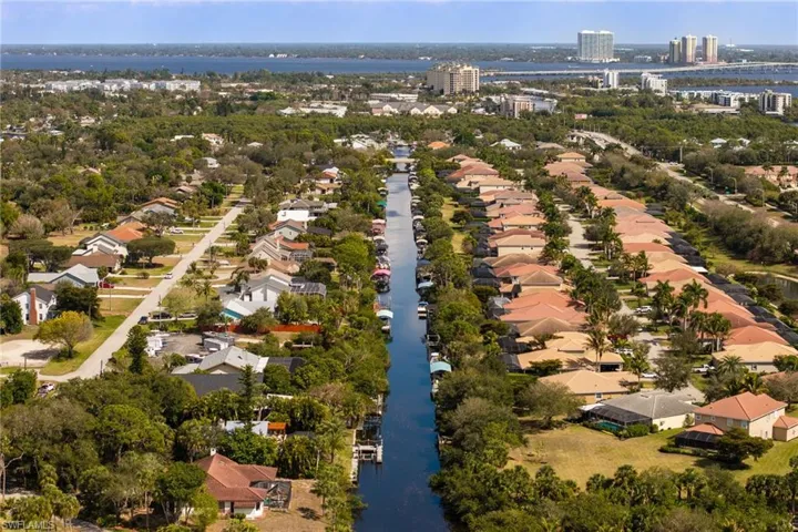 Aerial view of property's location with a large body of water and nearby suburban area
