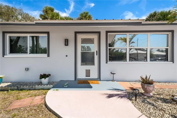 Property entrance featuring stucco siding