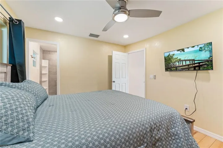 Bedroom with a ceiling fan, recessed lighting, and light wood finished floors