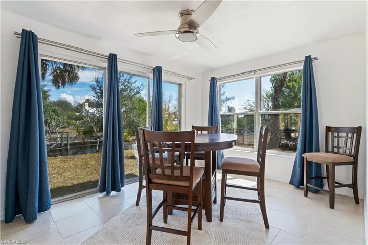Dining area with ceiling fan and light tile patterned floors