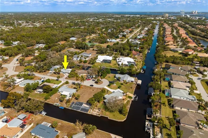 Aerial overview of property's location with nearby suburban area and a large body of water