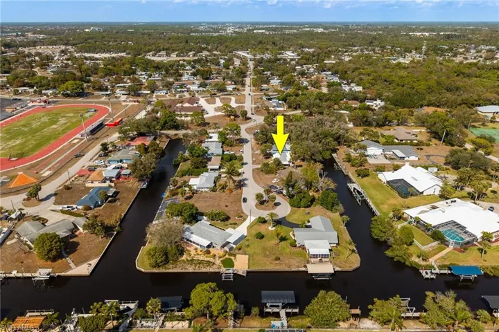 Aerial view of property's location featuring nearby suburban area and a nearby body of water